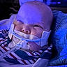 Lily is registered to the contest to win money with this photo: baby, infant, medical, breathing_tube, blanket, striped_clothing, face, closeup, hospital, healthcare, medical_equipment, child, young, person, blue_light, resting, wrapped, indoors, patient, cute