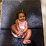 Elizah is registered to the contest to win money with this photo: baby, child, smiling, sitting, pink_dress, couch, indoor, happy, cute, infant, hands, feet, dark_hair, portrait, young_child, playful, comfortable, cozy, adorable, skin
