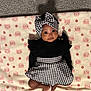 baby, infant, child, blanket, pattern, houndstooth, headband, bow, clothing, cute, face, eyes, smile, lying_down, carpet, soft_texture, pink, black, white, adorable