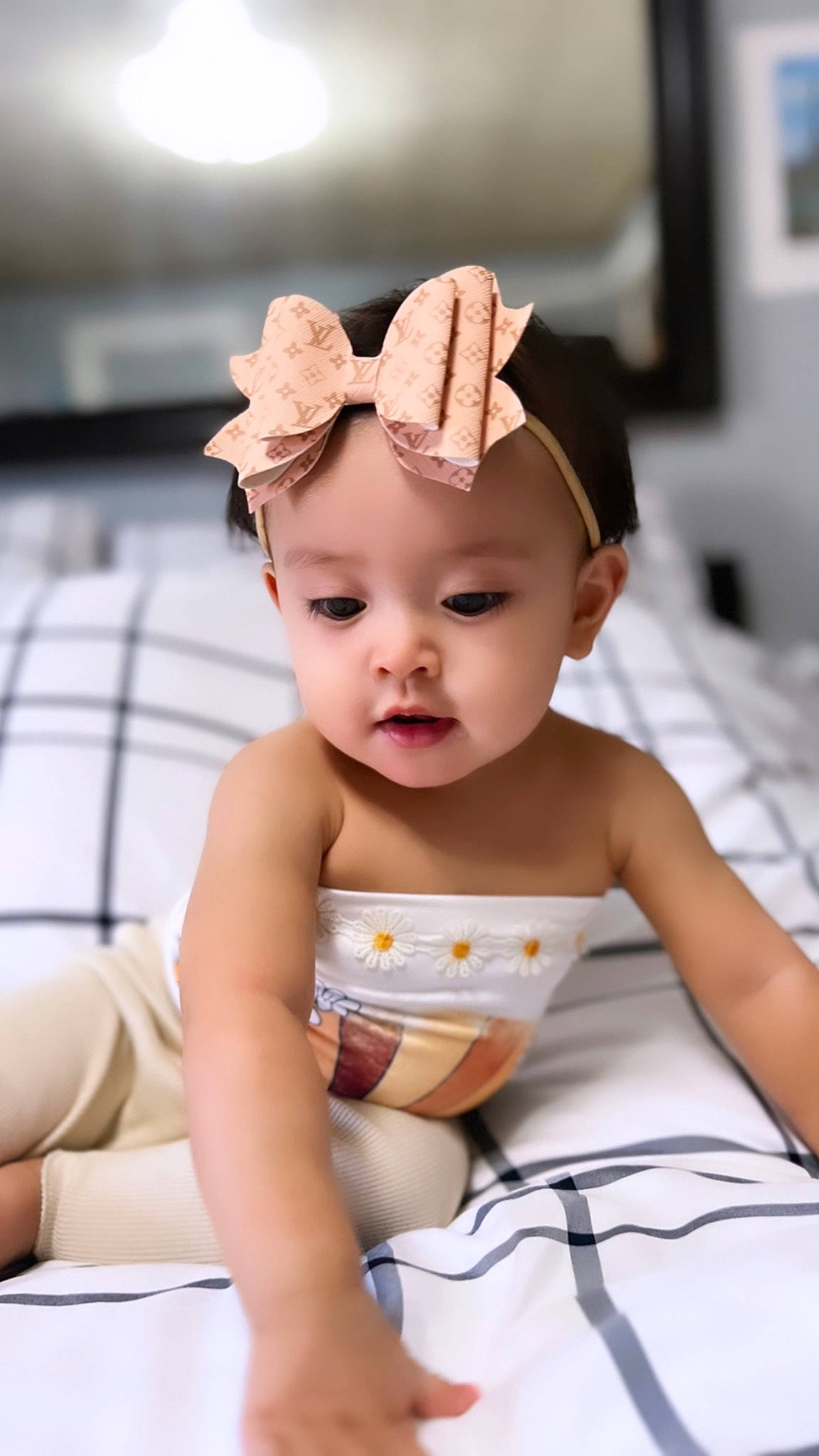 Delilah Rose is registered to the contest to win money with this photo: baby, baby_products, baby_toddler_clothing, cap, cheek, child, comfort, crown, fashion_accessory, finger, fun, hair_accessory, happy, headband, headpiece, headwear, human_leg, person, sitting, skin