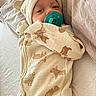 Brayden joined the competition — help win amazing prizes! baby, pacifier, onesie, hat, bed, bedding, infant, clothing, cute, sleepwear, pattern, animal_print, newborn, cozy, soft, portrait, lying_down, child, indoors, resting