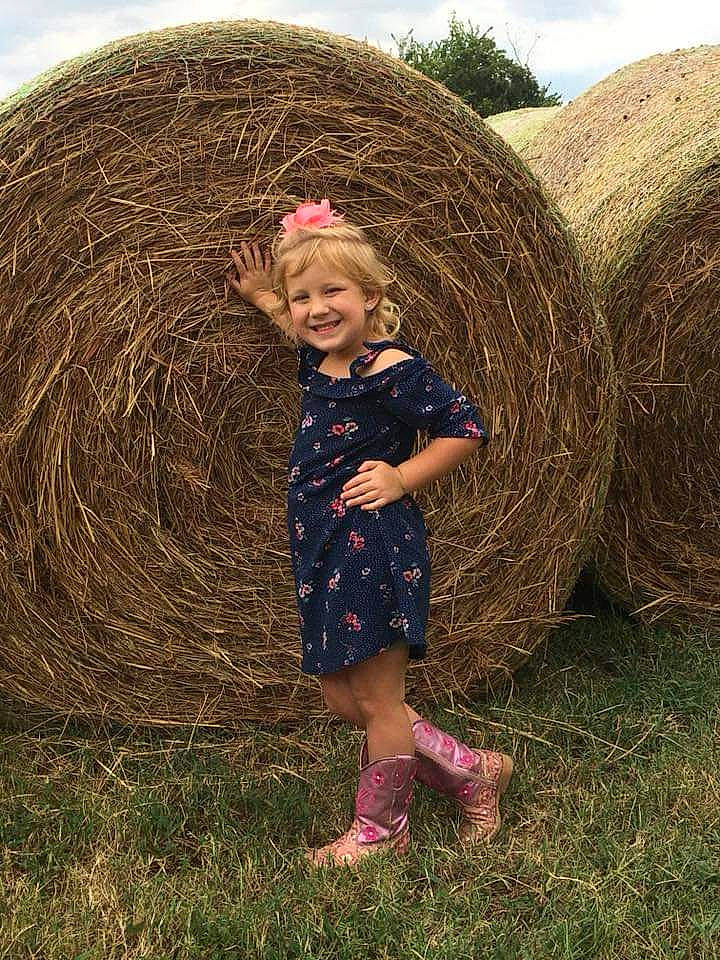 Maizy is registered to the contest to win money with this photo: agriculture, child, farm, field, fun, girl, grass, grass_family, hay, joy, person, plant, play, rural_area, shrub, soil, straw, tree