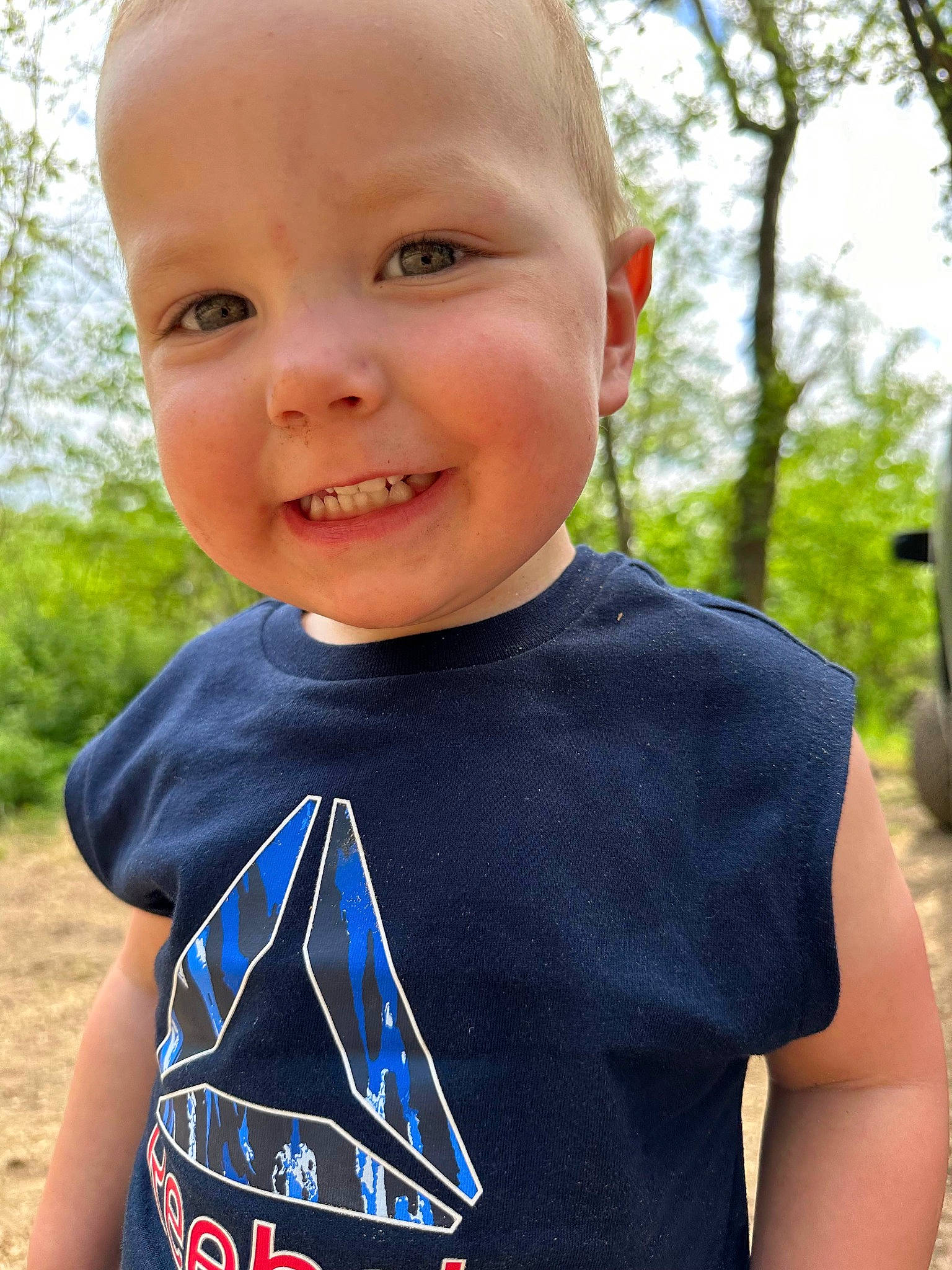 Zaydon is registered to the contest to win money with this photo: baby_products, baby_toddler_clothing, child, cool, electric_blue, facial_expression, fun, grass, happy, joy, leisure, mammal, neck, people_in_nature, person, recreation, sleeve, smile, t_shirt, toddler