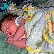 Lejend is registered to the contest to win money with this photo: baby, sleeping, blanket, curly_hair, infant, cozy, soft_texture, green_background, elephant_pattern, pillow, peaceful, child, indoor, cute, resting, newborn, wrapped, portrait, toddler, nap