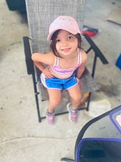 Josie Jacqueline is registered to the contest to win money with this photo: baby, baby_products, baseball_cap, cap, chair, child, electric_blue, fun, headwear, human_leg, joy, leg, leisure, magenta, person, recreation, shorts, sitting, smile, t_shirt