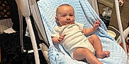 Acer is registered to the contest to win money with this photo: baby, infant, baby_swing, blanket, blue_blanket, white_clothing, indoor, floor, sofa, boots, cardboard_box, curious_expression, home_interior, wooden_floor, black_rug, baby_face, baby_boy, baby_girl, furniture, relaxing