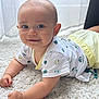 arms, baby, carpet, child, clothing, crawling, curtains, face, floor, happy, indoor, infant, natural_light, pants, patterned_clothing, person, smile, tshirt, white_carpet, window