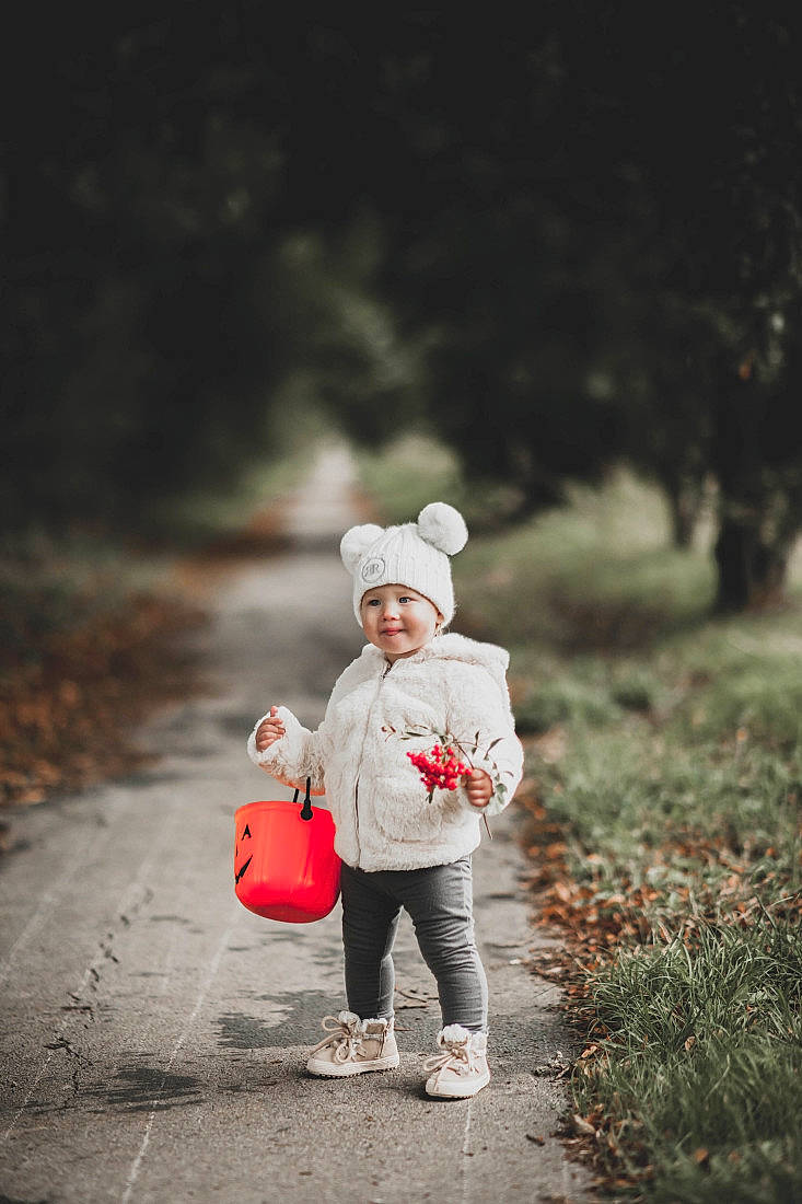 Keita is registered to the contest to win money with this photo: child, family, grass, happy, headwear, joy, people, person, photograph, photography, plant, portrait_photography, red, standing, toddler, tree, walking