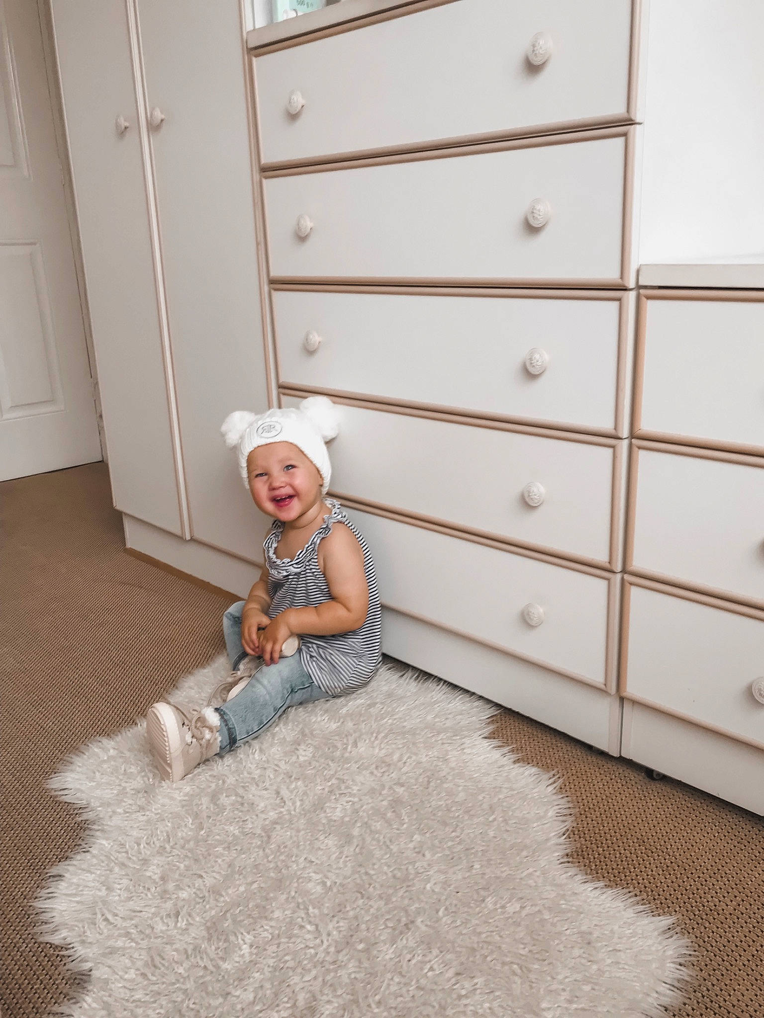 Keita is registered to the contest to win money with this photo: baby, carpet, chest_of_drawers, child, drawer, fawn, floor, flooring, footwear, fur, furniture, hardwood, home, interior_design, joy, laminate_flooring, person, room, shoe, toddler