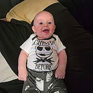 Ronin is registered to the contest to win money with this photo: apparel, baby, casual, child, clothing, couch, cute, expression, face, happy, indoor, infant, person, pillow, portrait, relaxing, sitting, smiling, toddler, young