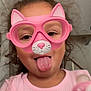 child, face, pink, glasses, virtual_filter, cat_ears, tongue_out, pacifier, indoor, curly_hair, playful, person, portrait, silly_face, young, cute, pink_shirt, fun, expression, headshot