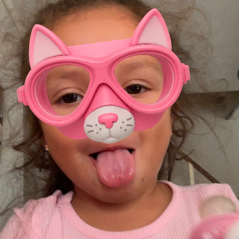 Nayeli joined the competition — help win amazing prizes! cat_ears, child, curly_hair, cute, expression, face, fun, glasses, headshot, indoor, pacifier, person, pink, pink_shirt, playful, portrait, silly_face, tongue_out, virtual_filter, young