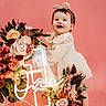 Oaklynne joined the competition — help win amazing prizes! baby, child, girl, smiling, barefoot, pink_background, flower_arrangement, neon_sign, first_birthday, headband, dress, happy, portrait, studio_photo, decor, celebration, cute, one_year_old, standing, holding