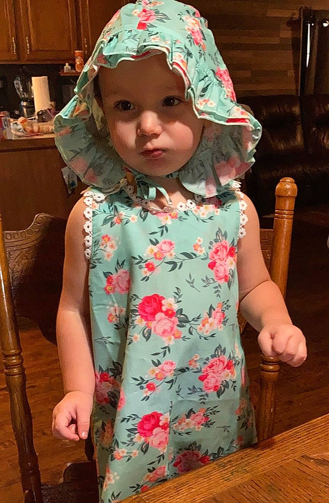 Kaisley joined the competition — help win amazing prizes! baby_toddler_clothing, cap, cheek, child, clothing, dress, eye, face, head, headwear, magenta, pattern, person, pink, skin, sleeve, standing, t_shirt, textile, toddler