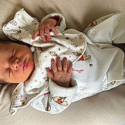 Andria participe au concours pour gagner de l'argent avec cette photo : newborn, baby, sleeping, onesie, cartoon_print, hand, face, cushion, soft_fabric, infant, peaceful, cozy, closeup, portrait, child, cute, resting, bedroom, comfort, blanket