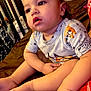 Mason joined the competition — help win amazing prizes! toddler, child, baby, sitting, indoors, clothing, shirt, puppy_print, legs, feet, hand, crib, blanket, furniture, curious, expression, face, skin, person, home