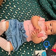Annalee joined the competition — help win amazing prizes! baby, infant, child, blanket, clothing, denim_shorts, pink_socks, headband, toy, hand, face, cute, lying_down, indoor, person, kneehigh_socks, playful, expression, fabric, colorful