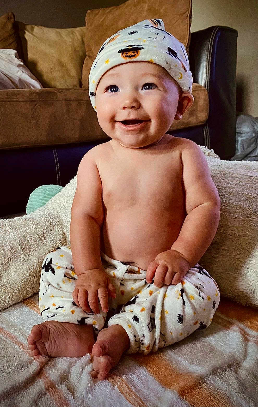 Candor joined the competition — help win amazing prizes! baby, child, smiling, sitting, pajamas, hat, indoors, blanket, cute, happy, face, feet, hand, living_room, couch, soft_toys, comfort, portrait, infant, cozy