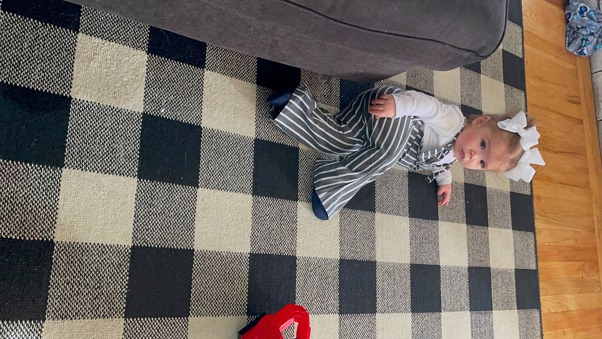 Mila joined the competition — help win amazing prizes! baby, comfort, dress, electric_blue, floor, flooring, grey, line, linens, pattern, person, plaid, rectangle, red, suit, tartan, textile, tints_and_shades, toddler, tree