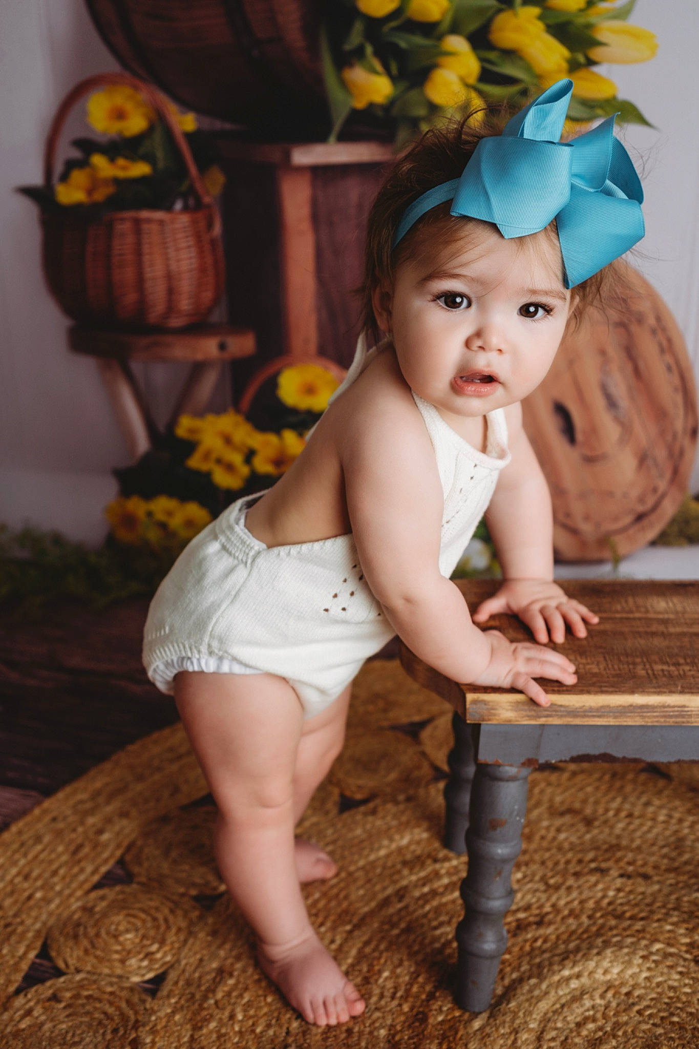 Mila is registered to the contest to win money with this photo: arm, baby, baby_toddler_clothing, chair, child, eye, face, fawn, flash_photography, flower, foot, happy, head, headwear, human_body, human_leg, iris, person, plant, skin