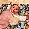 baby, infant, child, portrait, lying_down, smiling, wide_eyed, headband, bow, pink_outfit, overalls, blanket, animal_print, tiger_pattern, bed, milestone, two_months, wooden_sign, indoors, cute