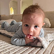 Haden joined the competition — help win amazing prizes! baby, infant, child, couch, blanket, pillow, indoors, home, cozy, cute, face, hands, clothing, sucking, curious, portrait, soft, texture, relaxed, lying_down