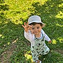 bucket_hat, child, cute, fashion, gesture, grass, greenery, happy, hat, mickey_mouse, nature, outdoor, overalls, person, playful, shoes, smile, sunlight, toddler, young_child
