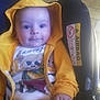 Timothée participe au concours pour gagner de l'argent avec cette photo : baby, car_seat, casual_clothing, child, cute, eyes, face, floor_tiles, hand, happy, hoodie, indoor, infant, pants, person, portrait, seated, smile, yellow_clothing, young_child