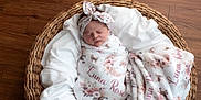Luna is registered to the contest to win money with this photo: baby, basket, blanket, child, cozy, cute, floral, headband, indoors, infant, newborn, peaceful, person, portrait, sleep, sleeping, soft, warm, wooden_floor, wrapped