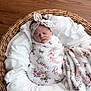 baby, basket, blanket, child, cozy, cute, floral, headband, indoors, infant, newborn, peaceful, person, portrait, sleep, sleeping, soft, warm, wooden_floor, wrapped