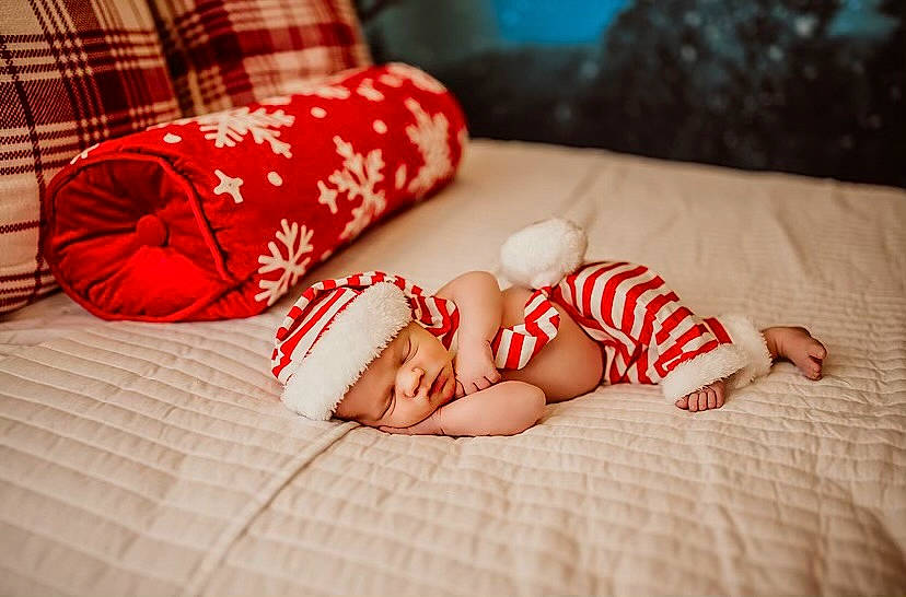 Colton joined the competition — help win amazing prizes! baby, baby_sleeping, comfort, eye, face, finger, flooring, foot, hand, happy, headwear, human_body, human_leg, knee, linens, nail, person, red, textile, thigh