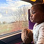 toddler, child, train, window, hat, knit, seat, purple_seat, looking_outside, curious, daylight, autumn, trees, reflection, clothing, indoor, portrait, young_child, travel, cozy
