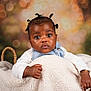 Maëlys a rejoint le concours — aidez-le/la à gagner de superbes lots ! baby, child, infant, basket, blanket, curly_hair, cute, portrait, indoor, studio, bokeh, expression, clothing, denim, white_sleeves, skin, face, hand, adorable, young