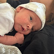 Soli joined the competition — help win amazing prizes! baby, infant, hat, white_clothing, blanket, closeup, face, skin, person, resting, comfort, soft_texture, sleepy, newborn, human, child, cuddle, headwear, portrait, young