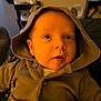 Soli joined the competition — help win amazing prizes! baby, hood, clothing, face, portrait, infant, blanket, warm_light, indoors, cute, buttoned_jacket, ears, soft, young_child, looking_up, cozy, seated, person, expression, home