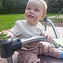 toddler, child, playground, outdoor, metal_bar, smile, happy, cute, clothing, pants, shirt, blue_socks, sunlight, green_grass, nature, park, person, face, play, joy