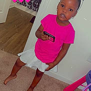 Tiana is registered to the contest to win money with this photo: accessories, child, clothing, dress, face, female, footwear, girl, hat, head, jewelry, person, photography, portrait, purple, sandal, shorts, skirt, t_shirt, wood