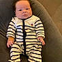 Maël participe au concours pour gagner de l'argent avec cette photo : baby, infant, striped_onesie, cushion, gray_cushion, soft_blanket, indoor, relaxed, portrait, newborn, child, cute, sleepwear, footed_pajamas, human, toddler, comfort, resting, head, face