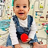 baby, child, smiling, play_mat, toy, red_toy, denim_overalls, white_shirt, barefoot, indoor, colorful_background, road_pattern, vehicles, hands, feet, happy, cute, portrait, infant, playtime