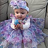 Alaina joined the competition — help win amazing prizes! baby, child, girl, dress, headband, butterfly_pattern, blue_egg, couch, furniture, indoor, curious, hands, sitting, cute, portrait, colorful, fabric, person, young_child, soft_lighting