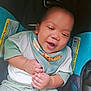 Mckayden is registered to the contest to win money with this photo: baby, infant, car_seat, smiling, clothing, bib, happy, child, seat, footwear, hand, indoors, person, cute, sitting, apparel, young_child, expression, comfort, baby_shoes