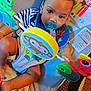 Mckayden is registered to the contest to win money with this photo: baby, baby_rocker, blue_bib, carpet, child, cute, feet, floor, indoor, infant, legs, monkey, pacifier, plastic_toy, playful, rainbow, smiling_face, striped_clothing, sun, toy