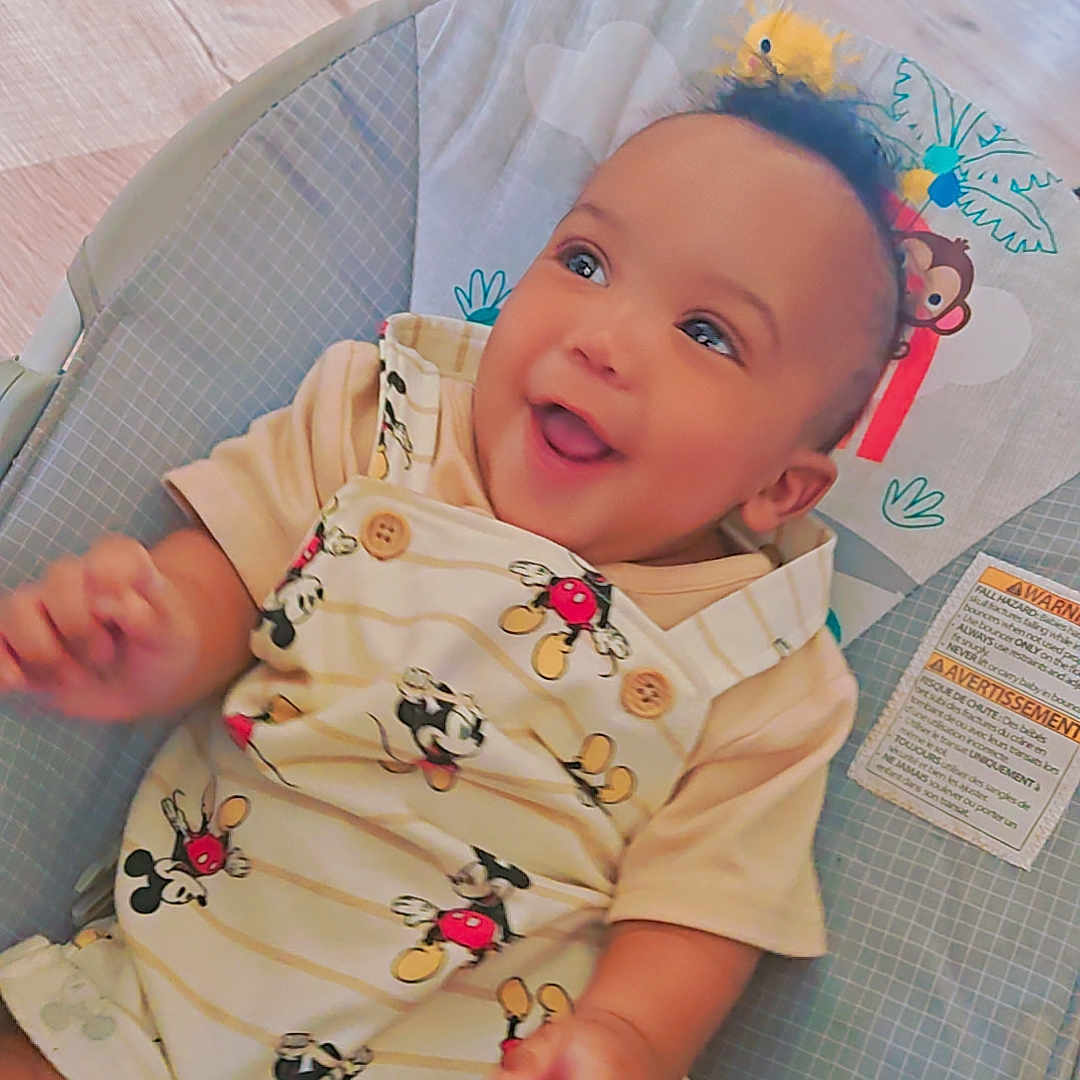 Mckayden is registered to the contest to win money with this photo: apparel, baby, baby_boy, baby_seat, child, clothing, cushion, cute, expression, happy, indoor, infancy, infant, joyful, mickey_mouse, person, playful, portrait, seat, smiling