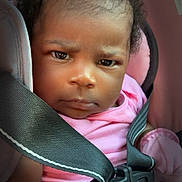 Elizabeth is registered to the contest to win money with this photo: baby, child, car_seat, seatbelt, pink_clothing, infant, face, portrait, serious_expression, curly_hair, safety, closeup, indoors, seat_strap, time_overlay, heart_doodle, young_child, person, cute, car_interior