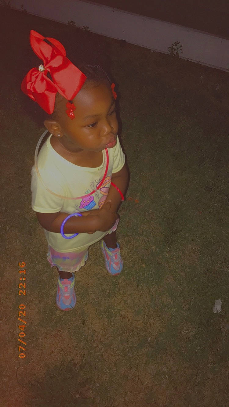 Zendaya joined the competition — help win amazing prizes! baby, baby_products, baby_toddler_clothing, carmine, child, fictional_character, floor, flooring, fun, grass, human_body, human_leg, knee, magenta, pattern, person, sitting, sleeve, sock, t_shirt