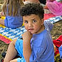 Taylin joined the competition — help win amazing prizes! child, boy, curly_hair, purple_shirt, blue_shorts, sitting, outdoor, picnic_blanket, grass, people, adult, food, drink, casual_clothing, daylight, event, relaxing, kids, nature, play