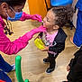 Serenity joined the competition — help win amazing prizes! child, dentist, dental_professional, mask, gloves, curly_hair, pink_clothing, black_jacket, yellow_toy, floor, chair, wooden_floor, medical_office, patient, healthcare, smile, person, shoes, interaction, indoor
