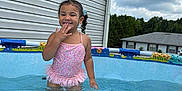 Serenity joined the competition — help win amazing prizes! child, girl, swimsuit, pool, water, summer, outdoor, backyard, house, sky, clouds, playful, happy, water_ripples, siding, daytime, person, cute, fun, smiling