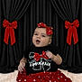 baby, child, polka_dot, red_skirt, headband, black_shirt, adorable, curtains, red_bows, portrait, cute, indoor, smiling, fashion, person, infant, sitting, dress, happy, studio