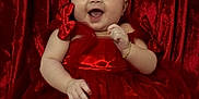 Alaia Susej is registered to the contest to win money with this photo: baby, child, red_dress, headband, smiling, happy, portrait, indoor, tulle, bow, jewelry, bracelet, infant, celebration, cute, person, fabric, red_background, festive, sitting